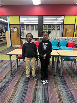 1 boy and 1 girl standing